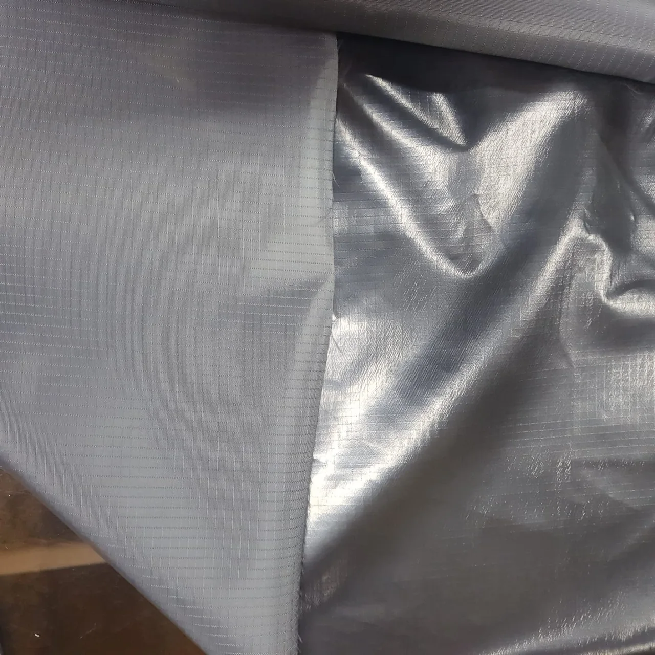 Grey woven fabric with silver backing