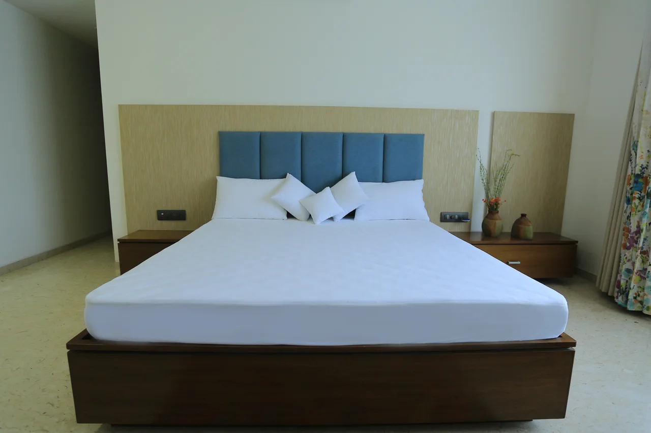 Front view of white bedding on a wooden bed